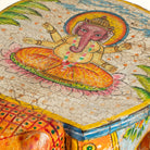 Close up image of a hand-painted wooden tiger side table featuring Indian folk art and floral details, shaped like a tiger with deity painting on top, perfect for vintage and India-inspired home accessories.