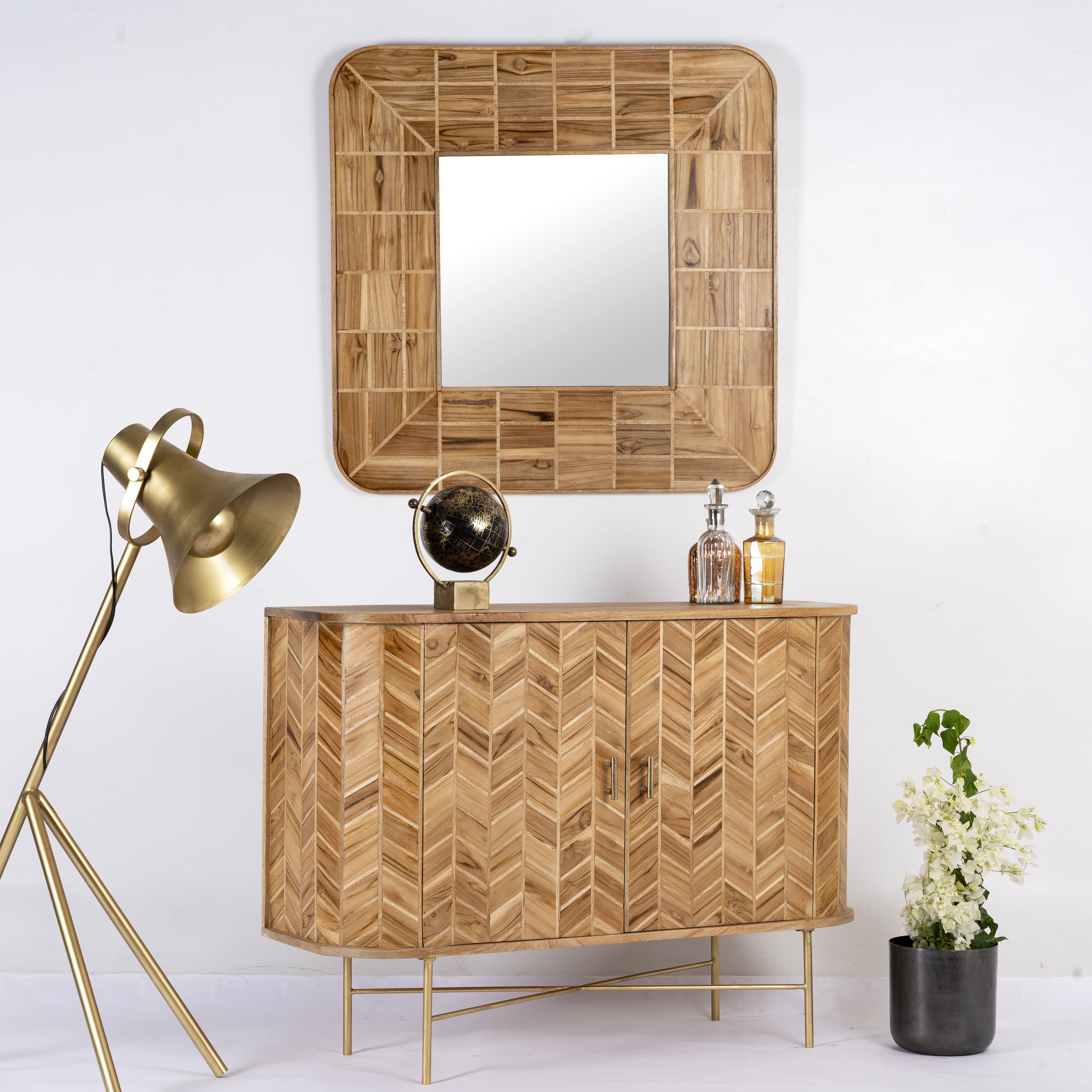 Side angle image of a handmade teak wood cabinet with chevron pattern, brass stand, and handles—minimalistic style living room furniture with modern and natural appeal.