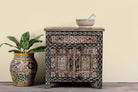 Image of a hand painted bedside cabinet made of reclaimed wood with one drawer and two doors in sanskrit style.