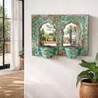Lifestyle imagination of a double arched hand-carved wooden mirror in distressed turquoise finish with two candle holders – ideal for Indian and vintage home accessories.