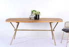Uddanda mango wood dining table featuring an intricately patterned natural wood tabletop with a brass-plated iron base and contemporary industrial design, 181cm.