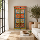Lifestyle image of a hand-painted teak wood cabinet with floral motifs; teak wood furniture for bohemian interiors, 105 × 55 × 177 cm.