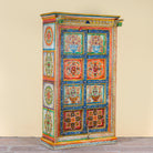 Side angle image of a hand-painted teak wood cabinet with floral motifs; teak wood furniture for bohemian interiors, 105 × 55 × 177 cm.