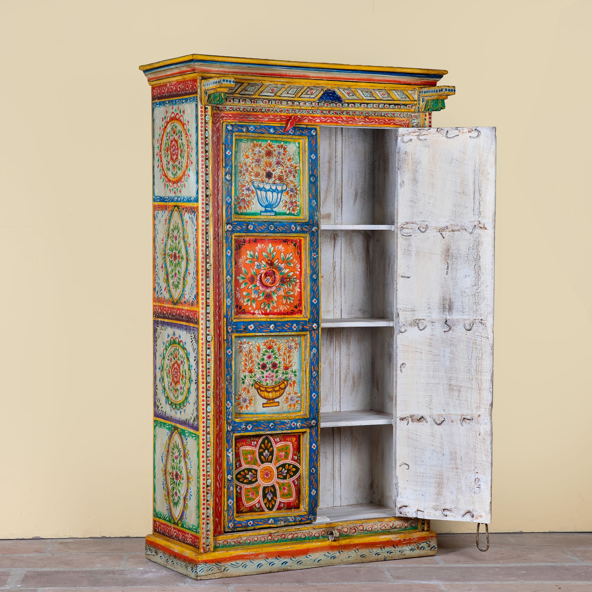 Open door image of a hand-painted teak wood cabinet with floral motifs; teak wood furniture for bohemian interiors, 105 × 55 × 177 cm.