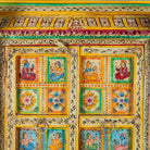 Close up image of a hand painted wardrobe made of teak wood with floral motifs; unique furniture inspired by Indian artistry, 104 × 50 × 186 cm.