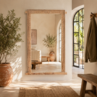 Lifestyle image of a Vadish antique Indian teak wood window mirror with bleached Ibiza-style finish, 156cm
