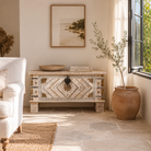 Lifestyle image of a handcrafted mango wood chest with brass inlays and carvings – wood chest box for boho style interiors, perfect as coffee table or bedroom storage.