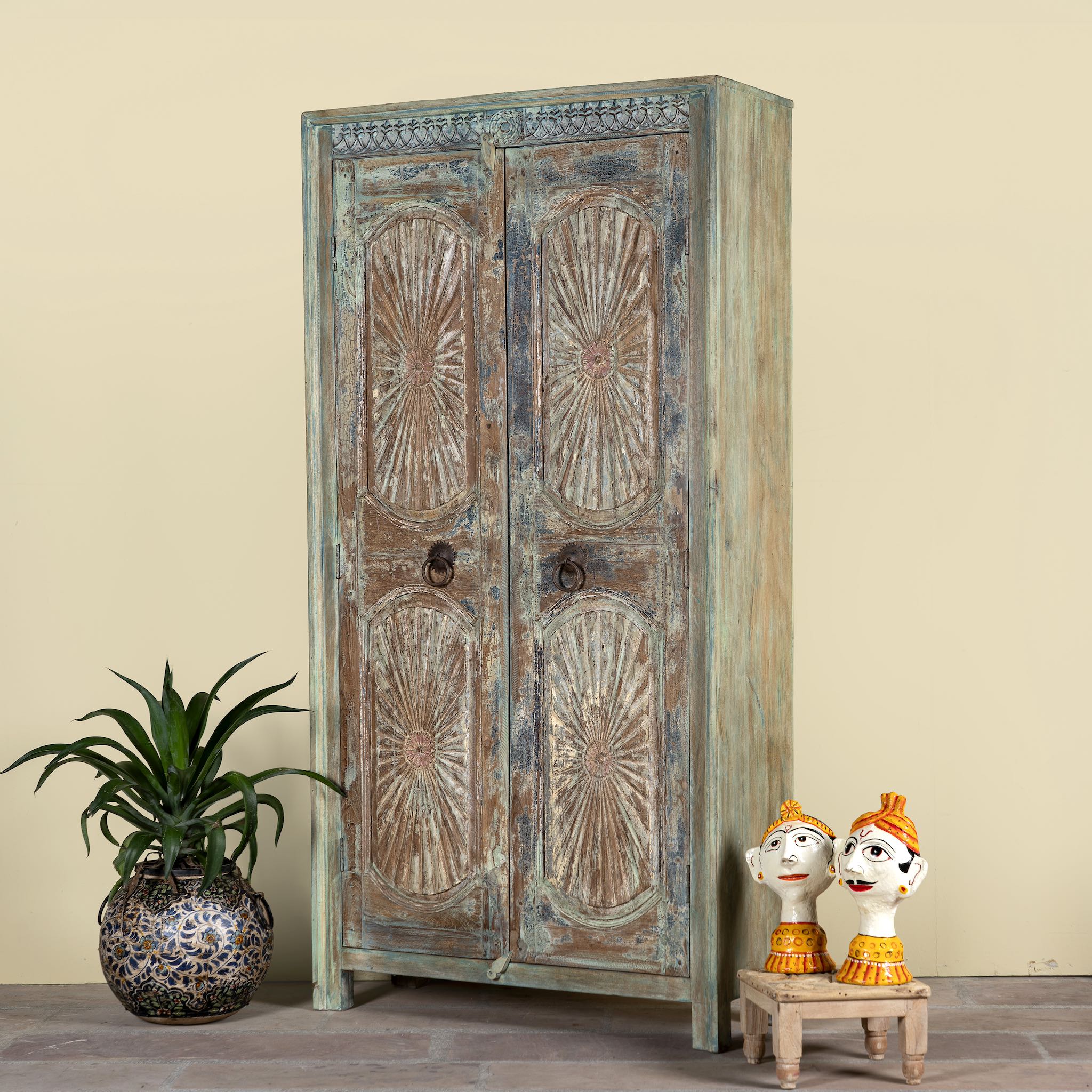 Side angle image of a hand-carved reclaimed wood wardrobe with vintage sunburst design – a sustainable furniture piece perfect for Indian home decor and rustic interiors.