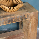 Close up image of a reclaimed teak wood bench with rustic finish and minimalist frame; sustainable furniture, 160 × 30 × 50 cm.