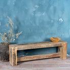 Side angle image of a reclaimed teak wood bench with rustic finish and minimalist frame; sustainable furniture, 160 × 30 × 50 cm.