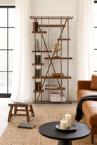 Lifestyle image of a brass-plated iron shelving unit with removable mango wood trays – minimalistic furniture and modular mango wood shelving for contemporary interiors.