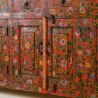 Close up image of a door of a hand painted sideboard made of reclaimed wood in boho design with ample storage.