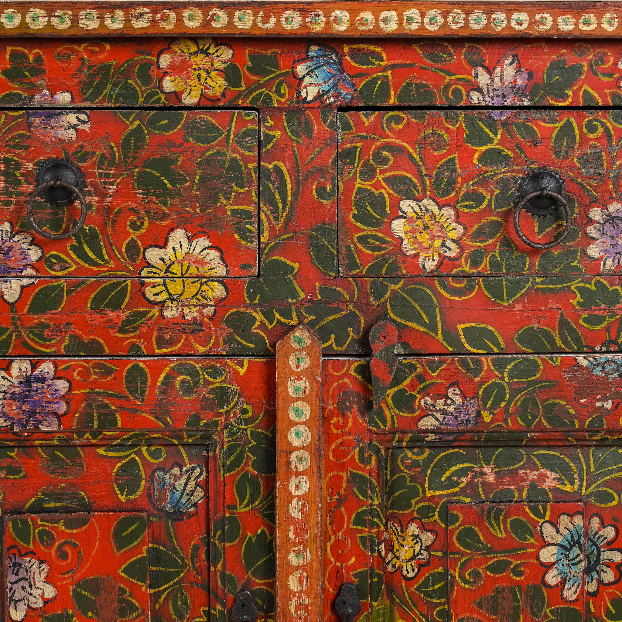 Close up image of a of a hand painted sideboard made of reclaimed wood in boho design with ample storage.