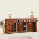 Side angle image with open doors of a of a hand painted sideboard made of reclaimed wood in boho design with ample storage.