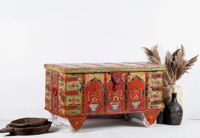 Side angle image of a unique Indian furniture box hand-painted on solid recycled teak – vibrant painted teak furniture ideal for living rooms or eclectic interiors.