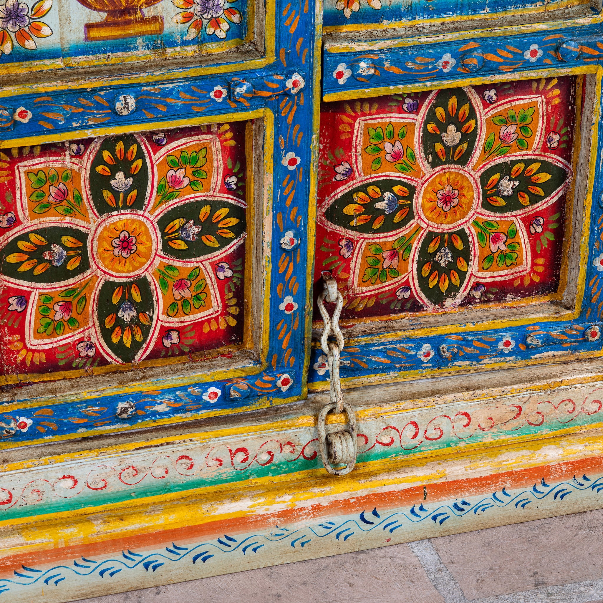 Close up image of a hand-painted teak wood cabinet with floral motifs; teak wood furniture for bohemian interiors, 105 × 55 × 177 cm.