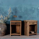 Side view image of a reclaimed wood bedside table with drawer and open shelf – handcrafted driftwood furniture designed for rustic minimalism and natural interiors.