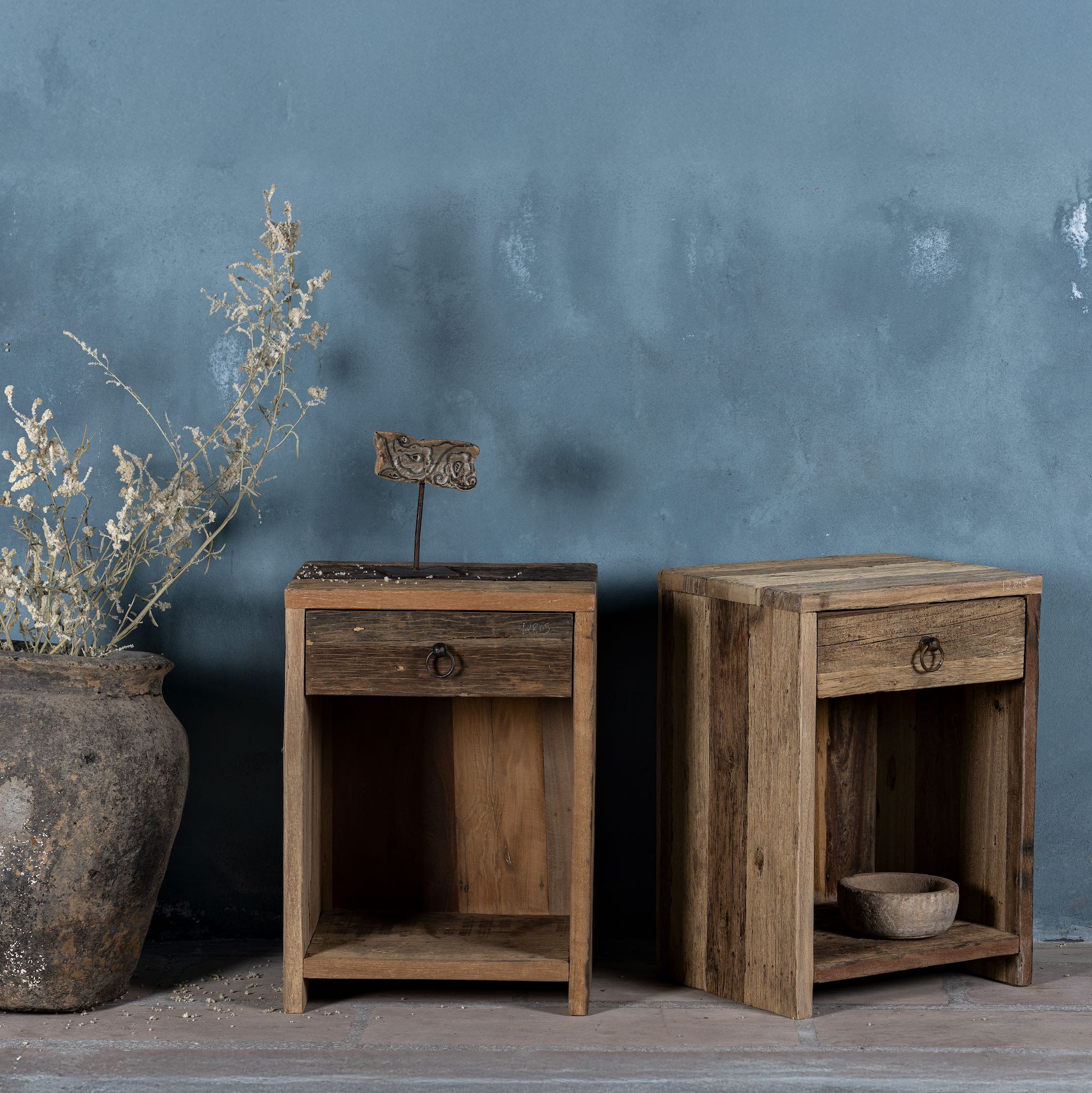 Side view image of a reclaimed wood bedside table with drawer and open shelf – handcrafted driftwood furniture designed for rustic minimalism and natural interiors.