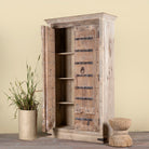 Side angle image with open doors of a hand-carved teak wood wardrobe with original iron fittings – Veena model by Om Home & Garden