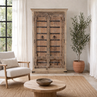 Lifestyle image with a Hand-carved teak wood wardrobe with original iron fittings – Veena model by Om Home & Garden