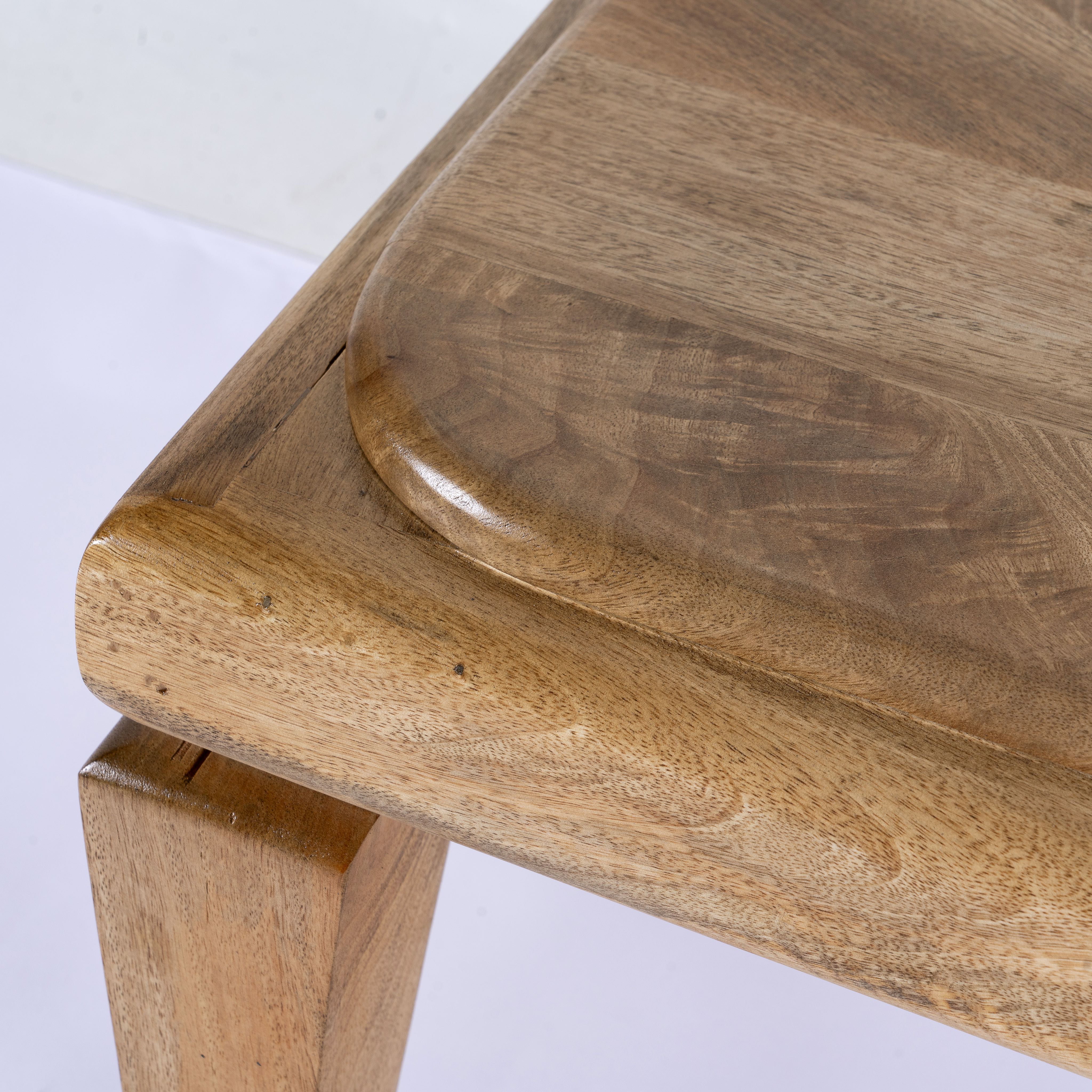 Close up image of a minimalistic mango wood bench with natural finish and clean design; versatile wooden seating, 180 × 41 × 44 cm.