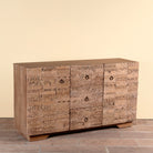 Side angle image of a Viara carved reclaimed wood sideboard with drawers, bleached finish and original hand-carved Indian teak house elements, 160x45x90cm