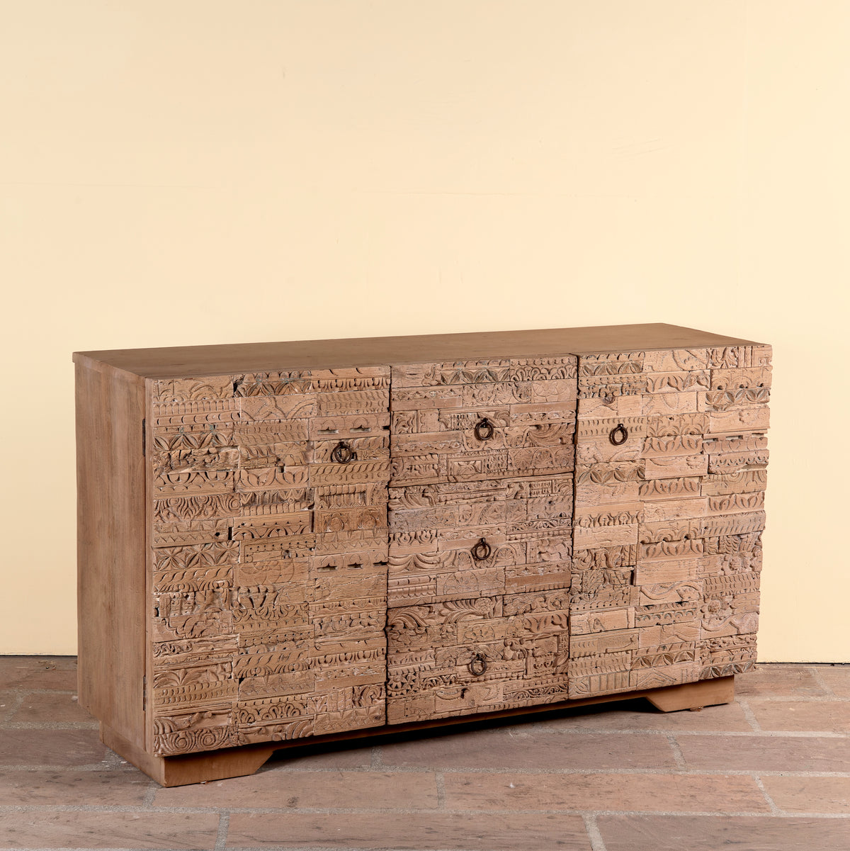 Side angle image of a Viara carved reclaimed wood sideboard with drawers, bleached finish and original hand-carved Indian teak house elements, 160x45x90cm