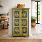 Lifestyle image of a hand painted wardrobe made of reclaimed wood with floral motifs; unique furniture for bedrooms or living rooms, 90 × 45 × 150 cm.
