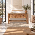 Lifestyle image of a Vihanraj reclaimed teak wood console table with original Indian door front, iron fittings and lower storage shelf 178cm