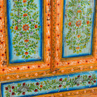 Close up image of a hand painted reclaimed wood showcase with 2 doors and one drawer.