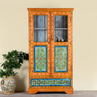 Lifestyle image of a hand painted reclaimed wood showcase with 2 doors and one drawer.