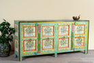 Side angle image of a vintage green sideboard reclaimed wood  with hand painted floral motifs and distressed finish; artisanal storage furniture for bohemian interiors, 170 × 40 × 104 cm.