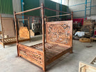 Factory image of a Vishika hand carved mango wood four poster bed with teak finish, ornate floral carved headboard and footboard, for 180x200cm mattress.