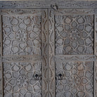 Close up image of a Vishyali hand carved grey mango wood wardrobe with geometric carved doors 180cm