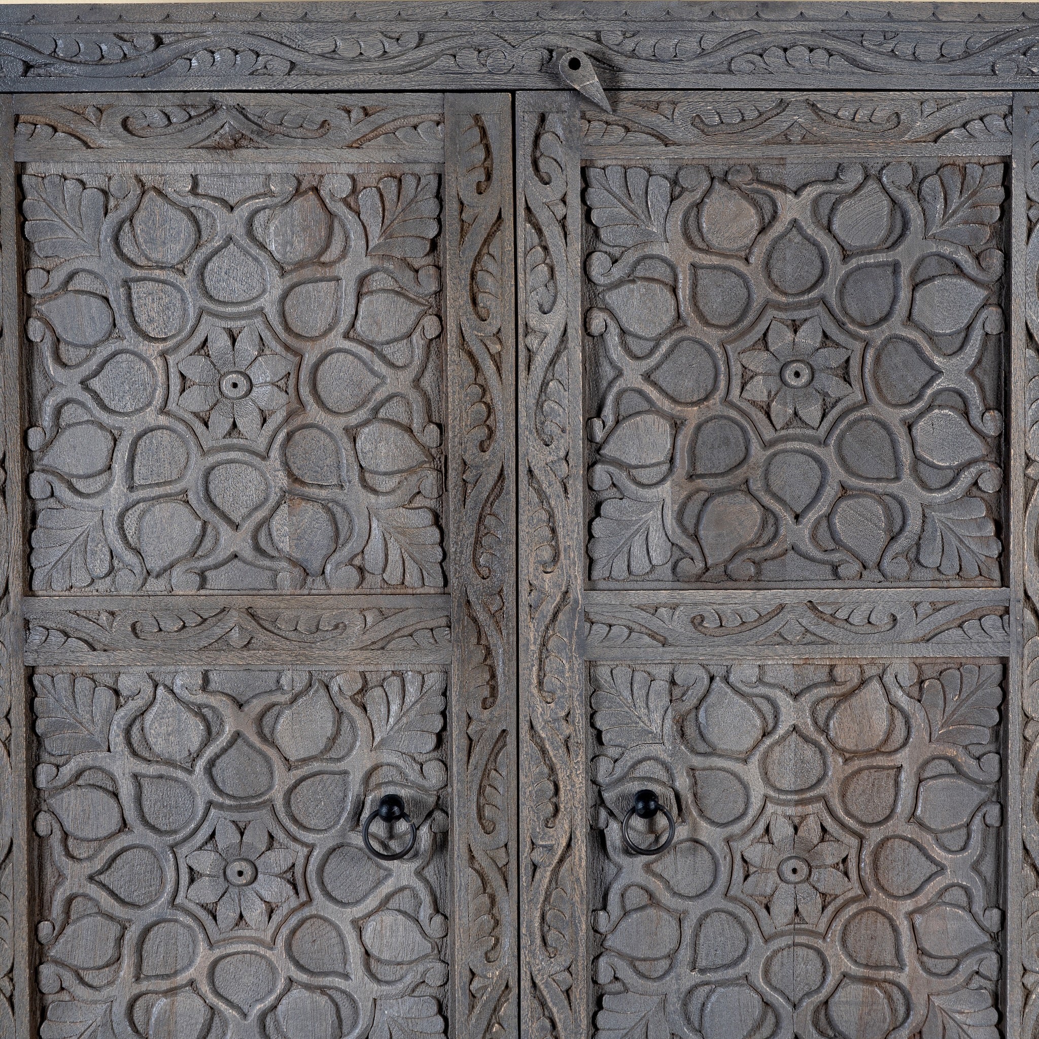 Close up image of a Vishyali hand carved grey mango wood wardrobe with geometric carved doors 180cm