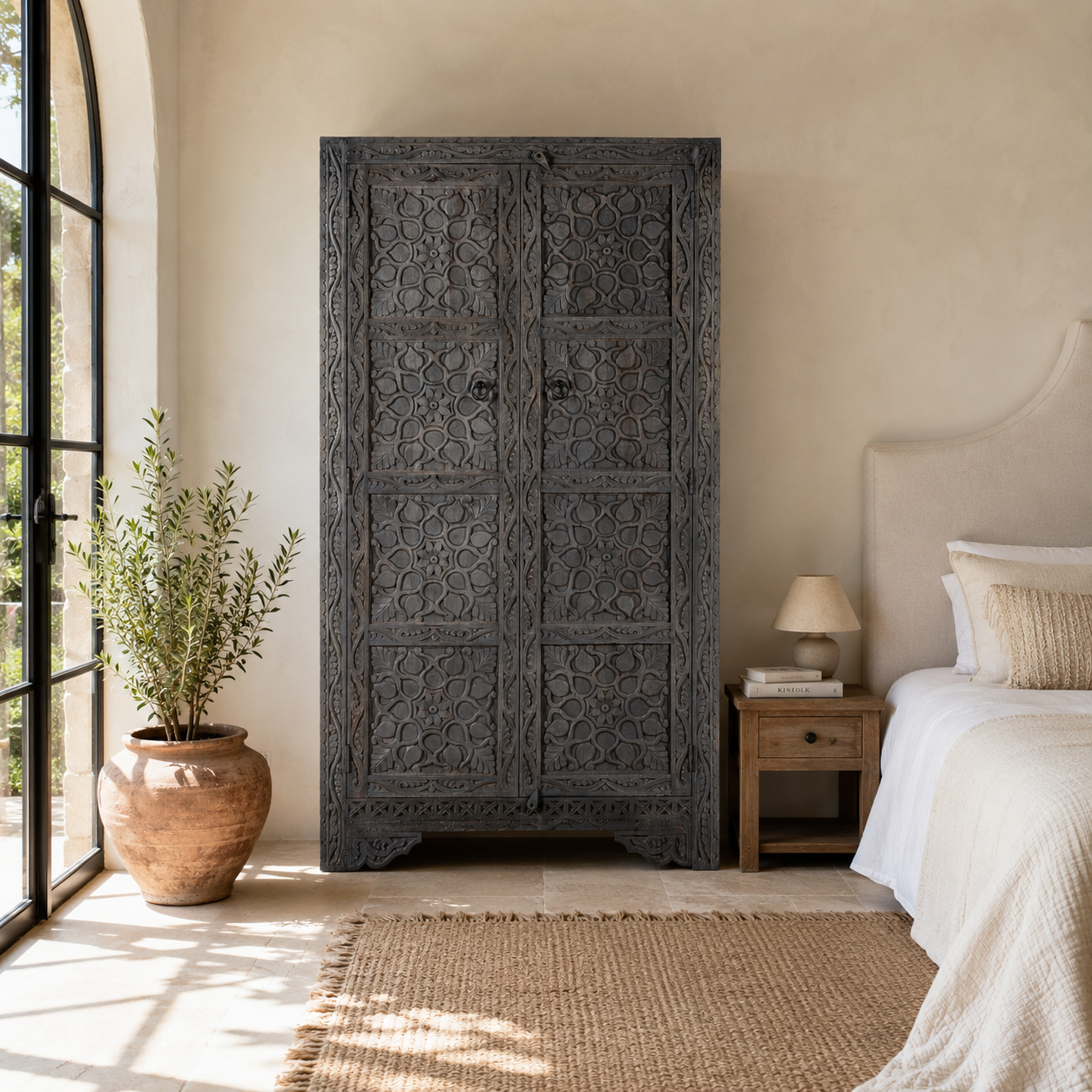 Lifestyle image of a Vishyali hand carved grey mango wood wardrobe with geometric carved doors 180cm