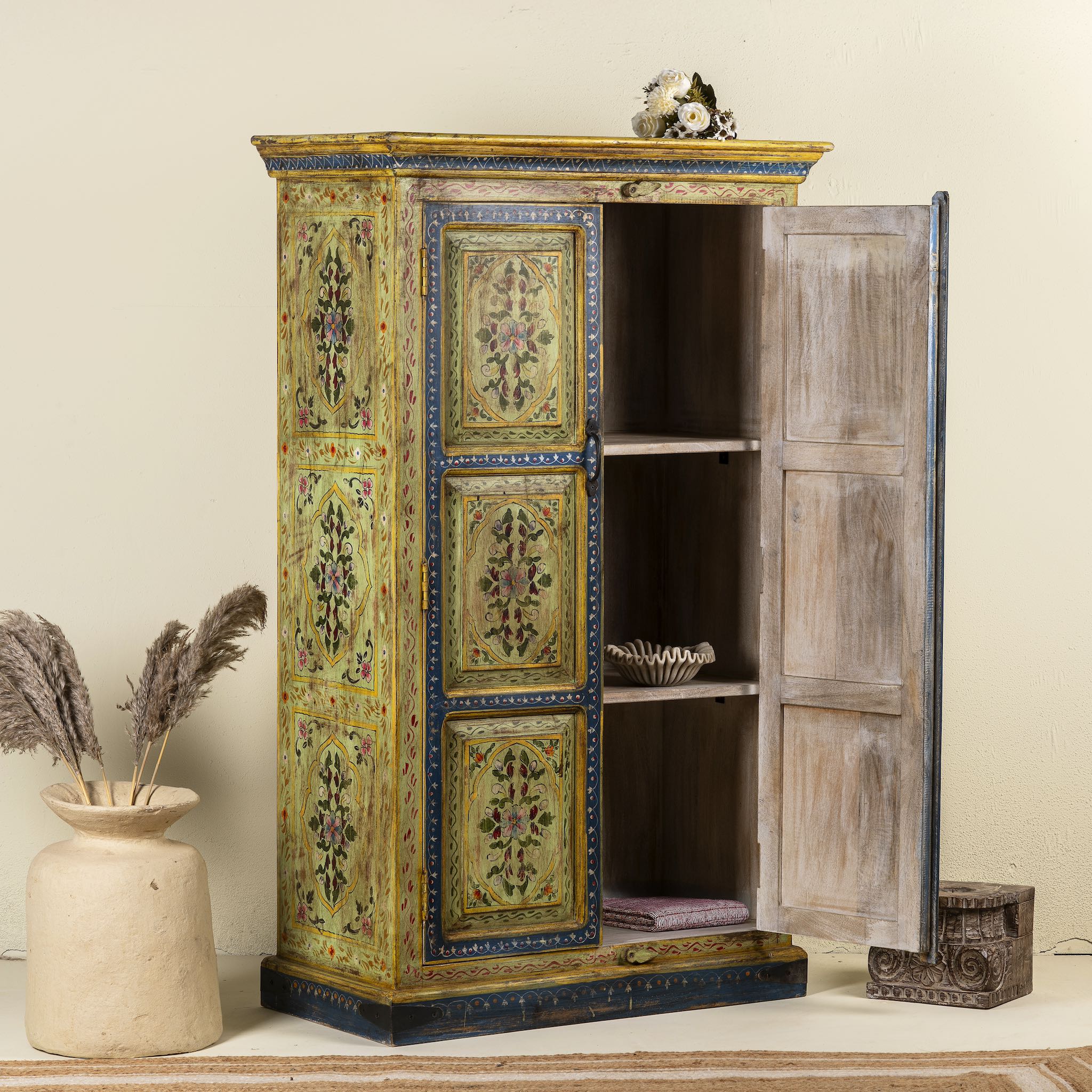 Open door image of a hand painted wardrobe made from reclaimed wood with floral motifs and distressed finish; ideal for a boho chic living room or eclectic bedroom, 90 × 40 × 150 cm.