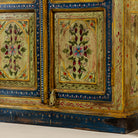Close up image of a hand painted wardrobe made from reclaimed wood with floral motifs and distressed finish; ideal for a boho chic living room or eclectic bedroom, 90 × 40 × 150 cm.