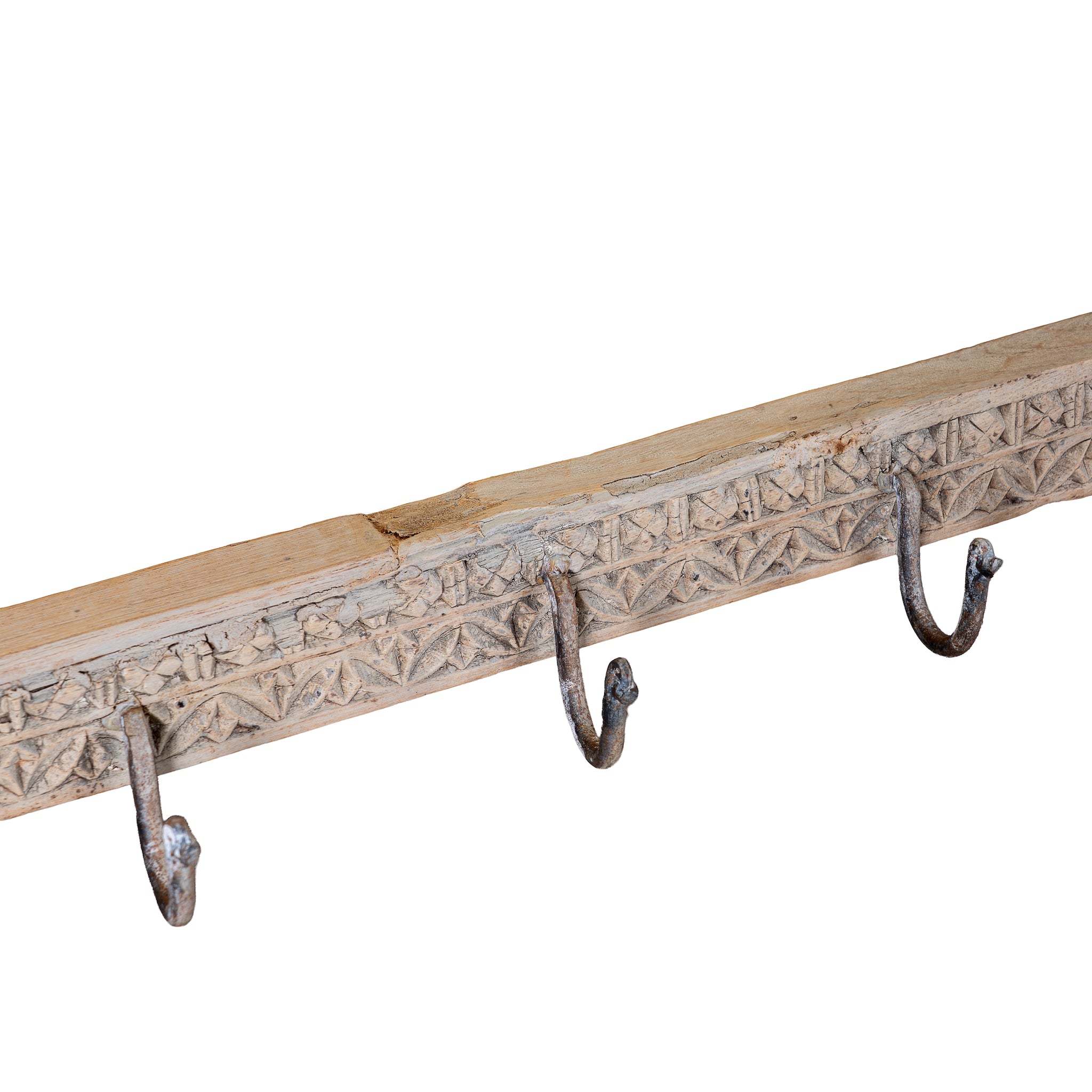 Close up image of a Maharaja Hook Rack handcrafted from an antique Indian reclaimed wood architectural element with hand-carved floral details, bleached finish and eight iron hooks, 150x7x5cm.