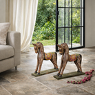 Lifestyle imagination of a Hand-painted decorative wooden horse made from reclaimed wood with colourful saddle design – a vintage Indian home accessory full of character.