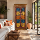 Lifestyle image of a hand-painted cabinet made from reclaimed teak wood with colourful Indian motifs – sustainable furniture and vintage teak wood craftsmanship for bold interiors.