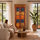 Lifestyle image of a hand-painted cabinet made from reclaimed teak wood with colourful Indian motifs – sustainable furniture and vintage teak wood craftsmanship for bold interiors.