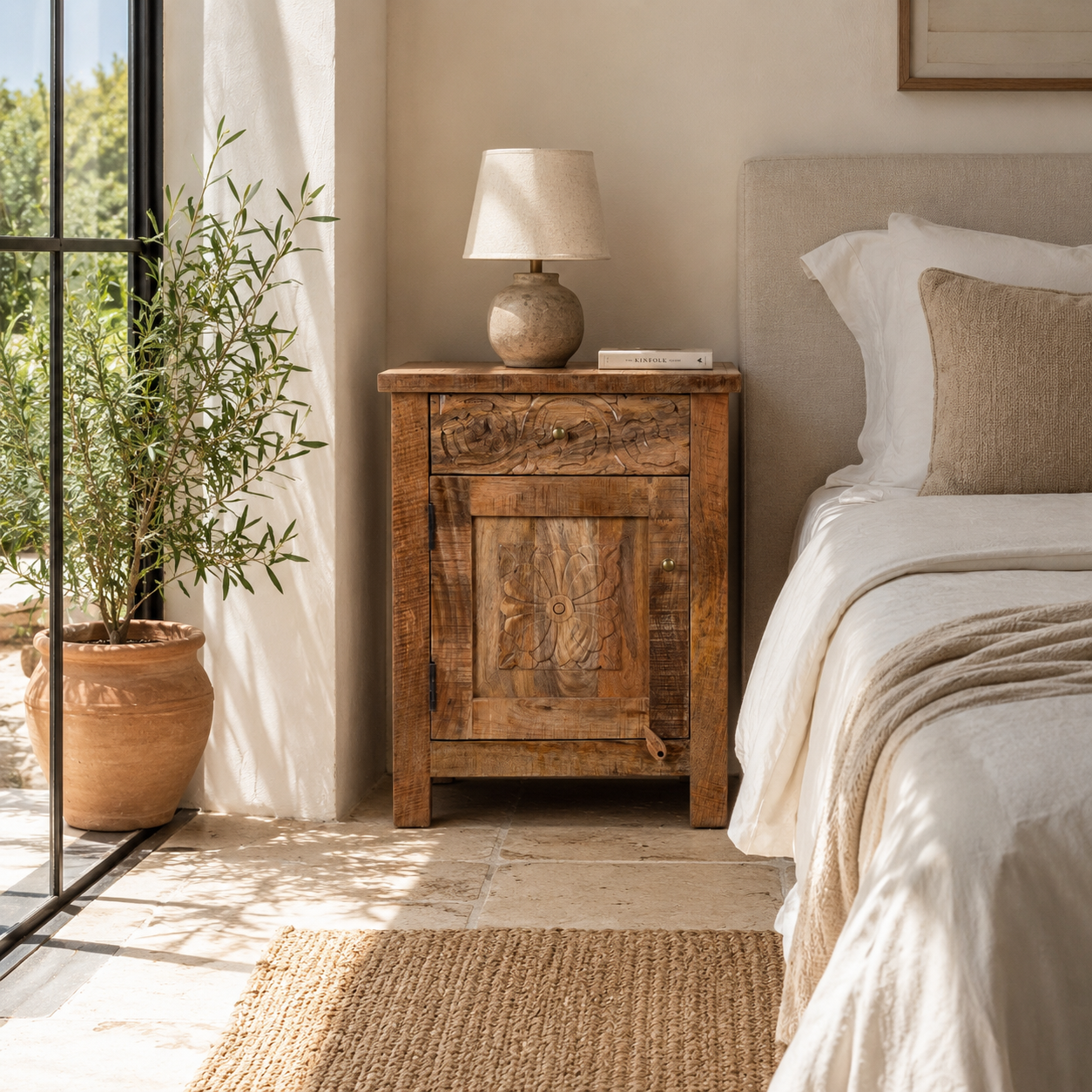 Lifestyle image of a image of a Yana set of two hand carved mango wood bedside tables with drawer and cupboard 65cm