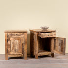 Side angle image with open doors of a Yana set of two hand carved mango wood bedside tables with drawer and cupboard 65cm