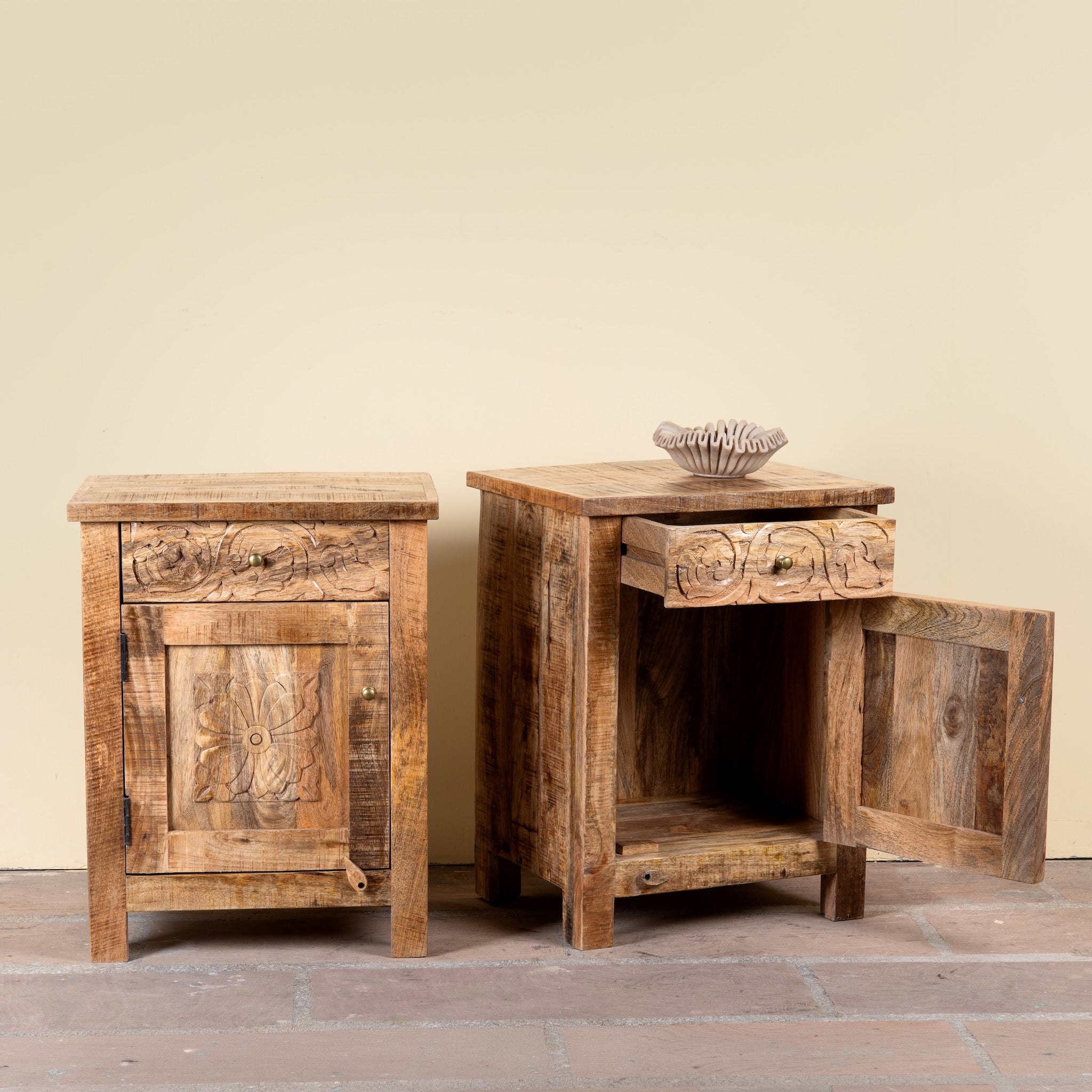 Side angle image with open doors of a Yana set of two hand carved mango wood bedside tables with drawer and cupboard 65cm