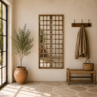 Lifestyle image of a antique teakwood mirror made from a traditional Indian door with iron details and mirror inlays – perfect as a reclaimed wood mirror for vintage home decor.