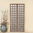 Antique teakwood mirror made from a traditional Indian door with iron details and mirror inlays – perfect as a reclaimed wood mirror for vintage home decor.