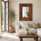 Lifestyle image of a hand made reclaimed wood mirror in rustic design.