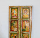 Close up image of a hand-painted Indian antique teak door with Hindu gods, elephants, and folk art, reclaimed wood vintage wall panels for vintage home decor.