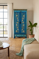 Lifestyle imagination of a of a hand-painted wardrobe made of reclaimed wood in vibrant blue floral design – Yuvika model by Om Home & Garden